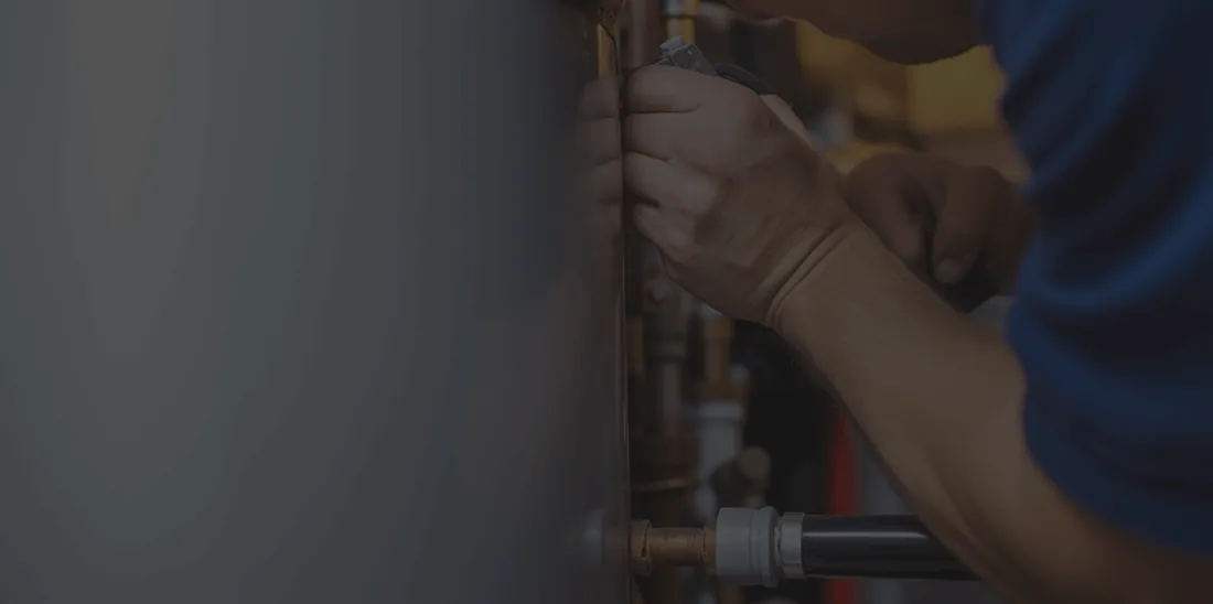 Heating engineer working on a central heating radiator valve in Cardiff